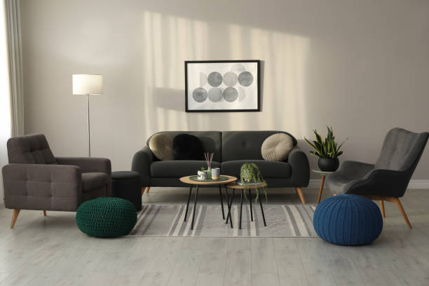 istock Stylish comfortable poufs and sofa in room. Home design 1445395211