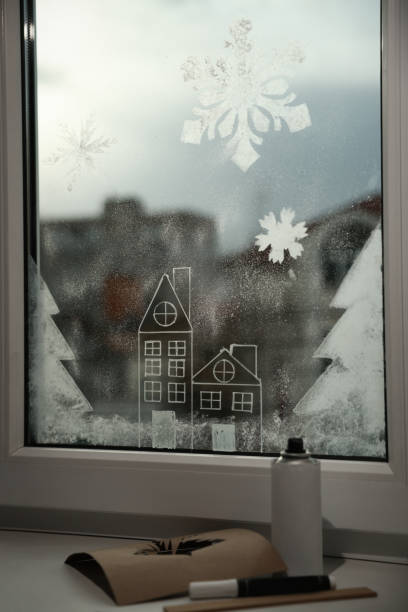 istock Beautiful drawing made with artificial snow on window at home. Christmas decor 1445397031