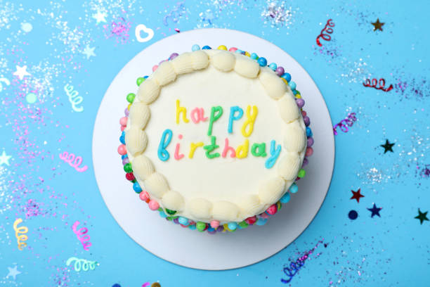 istock Cute bento cake with tasty cream and confetti on light blue background, flat lay 1445400702