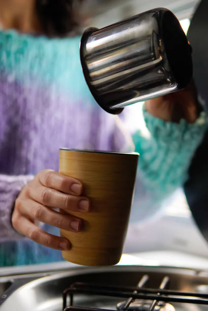 istock making breakfast in a camper van with the steam from boiling water. nomadic life in camping 1445401139