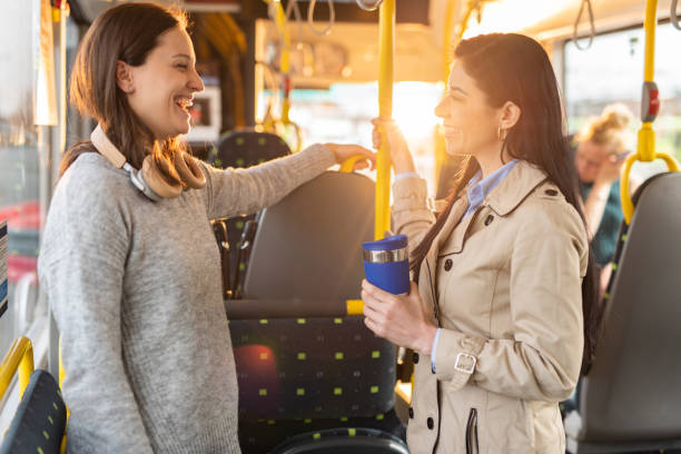 istock Female friends talking while traveling by bus 1445403925