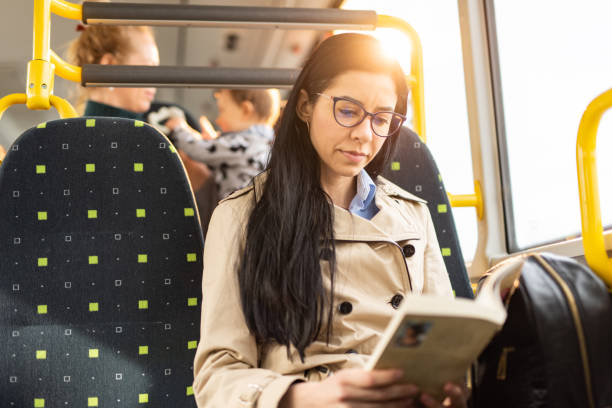 istock Woman reading a book while traveling by bus 1445404352