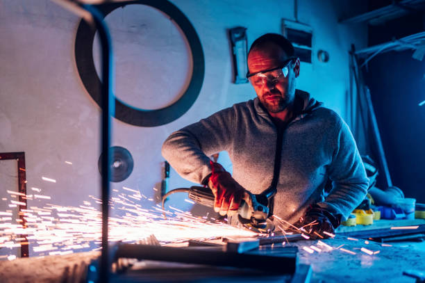 istock Worker in a factory grinding metal with a grinder 1445405242