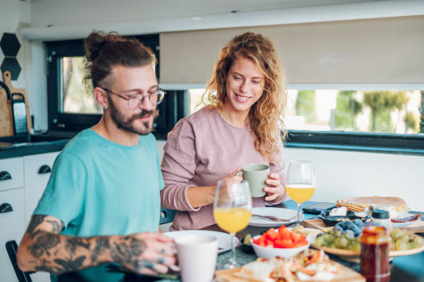 istock Couple eating breakfast together while sitting at table at home 1445405281