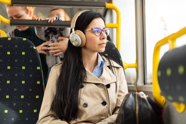 istock Woman using headphones in bus 1445405496