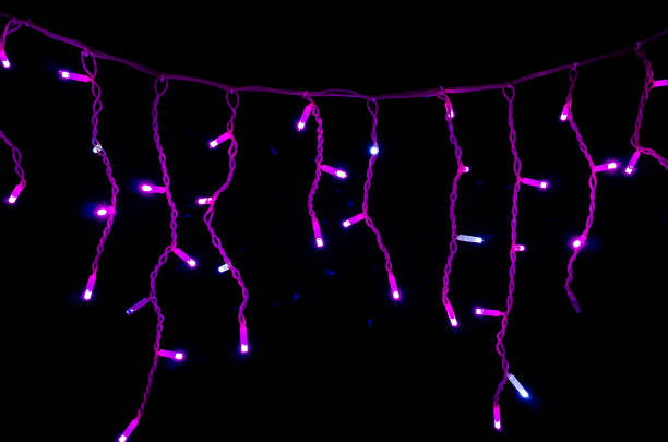 istock Colored Christmas garlands on black background. 1445406500
