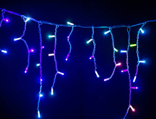istock Colored Christmas garlands on black background. 1445406645