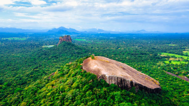 Sri lankas famous tourist places Sigiriya and pirdurangala Sigiriya World Heritage Site, Back of Beyond Pidurangala is situated in a lovely unfenced 4 acre forest, a mere 5 minutes from the Sigiriya Rock. dambulla stock pictures, royalty-free photos & images