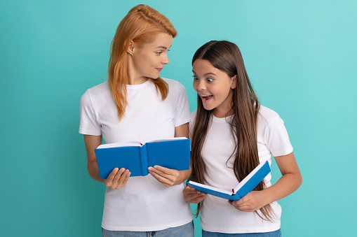 family help. mother and daughter hold books. friendship. back to school. childhood education. curious pupil and student. mom and teen girl study. private teacher and child holding workbooks.