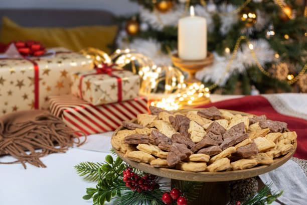 istock Christmas gift table set with gingerbread and candle with garland lights 1445410424