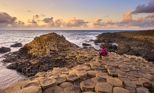 atlantic coastline with Volcanic hexagonal basalt columns of Giant`s Causeway at sunset in Northern Ireland