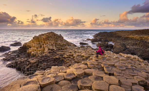 Volcanic rock formation of Giant`s Causeway in Ireland atlantic coastline with Volcanic hexagonal basalt columns of Giant`s Causeway at sunset in Northern Ireland giants causeway stock pictures, royalty-free photos & images