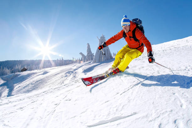 istock Skier skiing downhill in high mountains against blue sky. 1445412291