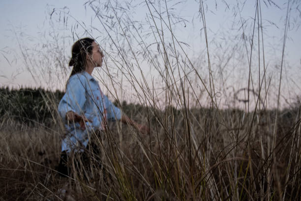 istock A girl walks through meadow 1445412387