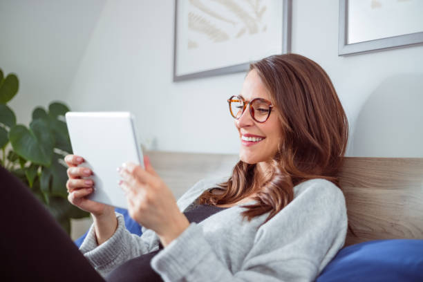 istock Pregnant woman using digital tablet in bed 1445414065