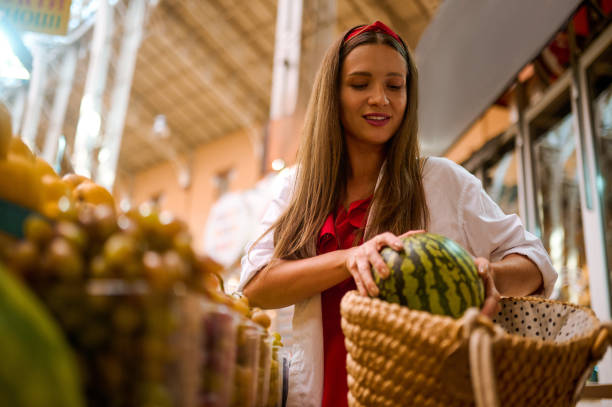 istock A young woman puting a watermelon into her bag 1445419775