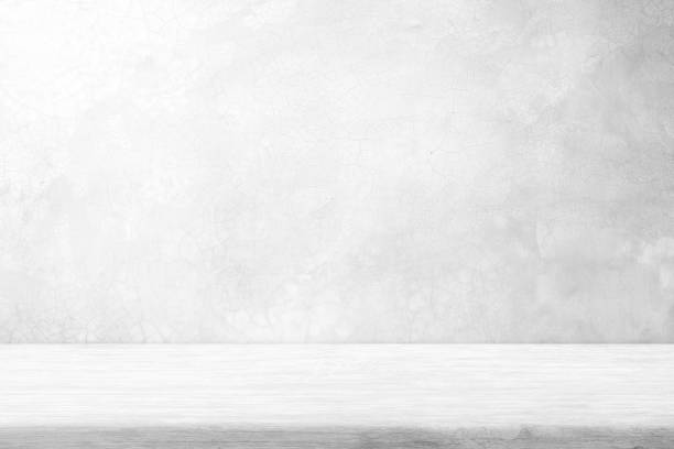 istock White Wood Table with Polished Raw Concrete Wall with Crack Texture on Surface Background, Suitable for Product Presentation Backdrop, Display, and Mock up. 1445420427