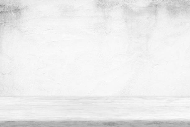 istock Wooden Table with White Grunge Concrete Wall Background, Suitable for Product Presentation Backdrop, Display, and Mock up. 1445420438