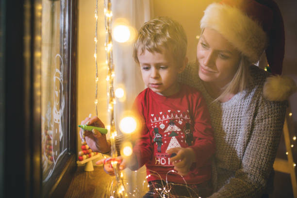 istock Little boy draws on a window in the winter 1445420596