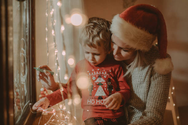 istock Little boy draws on a window in the winter 1445422448