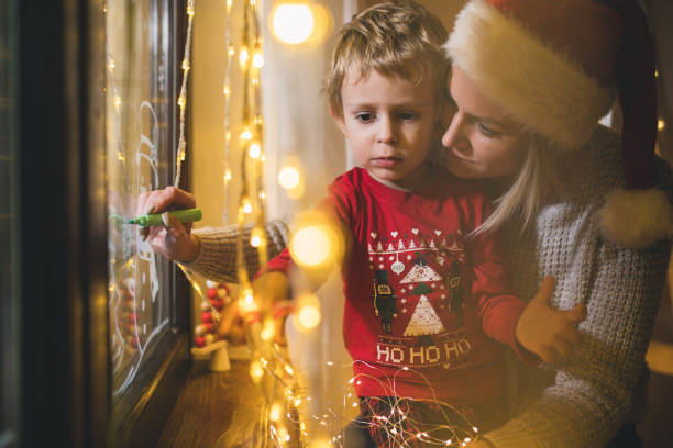 istock Little boy draws on a window in the winter 1445422608