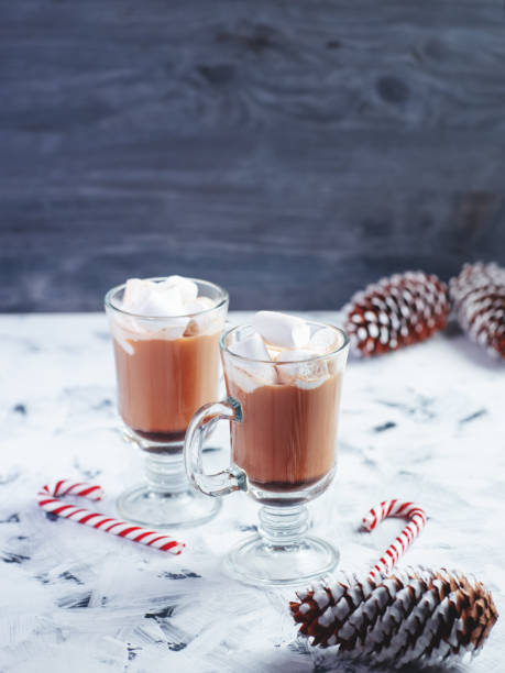 istock Two glasses of cocoa with marshmallows on a white table 1445422768