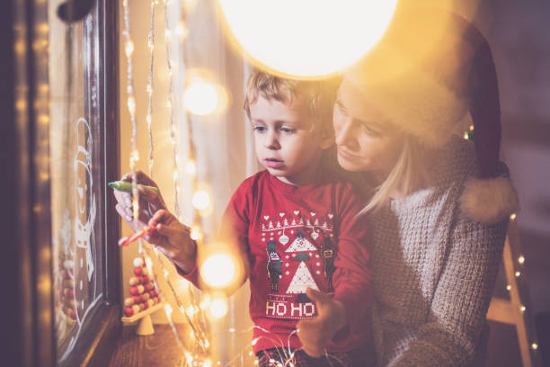 istock Little boy draws on a window in the winter 1445422851