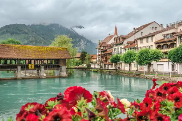 View of the old medieval wooden dam and the mill on the river Aare. Interlaken. Switzerland.