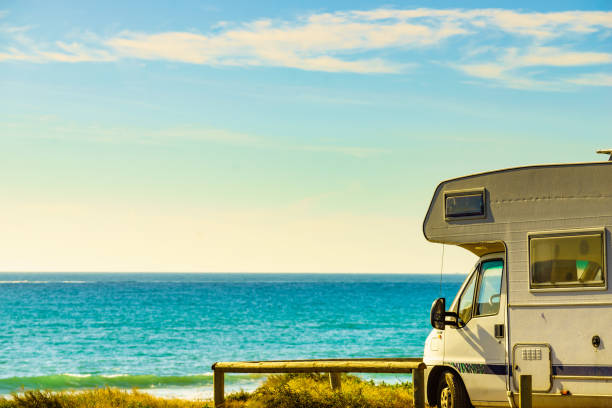 istock Camper rv camping on sea shore, Spain 1445423676