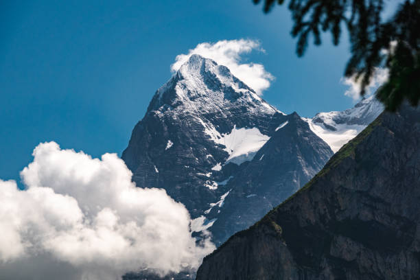 Fog Clings To The North Face Wall Of The Eiger in the Swiss alps