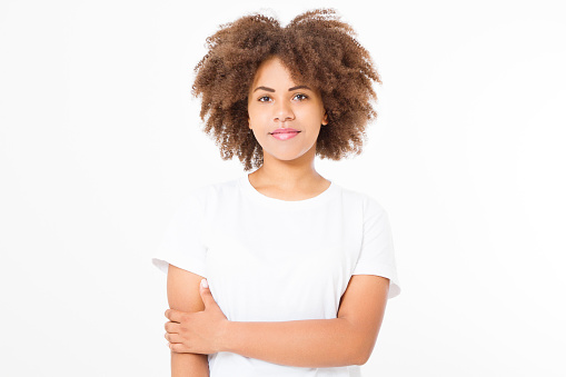 Smiling young african american woman with perfect skin care and healthy curly afro hair isolated on white background. Blank t shirt and summer concept. Copy space