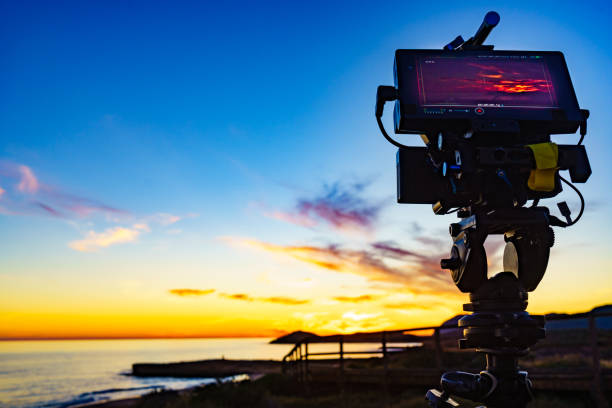 istock Camera taking picture of sunset over sea 1445425320