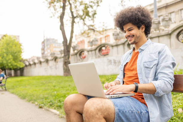 istock Man sitting outdoors and working via laptop 1445425355