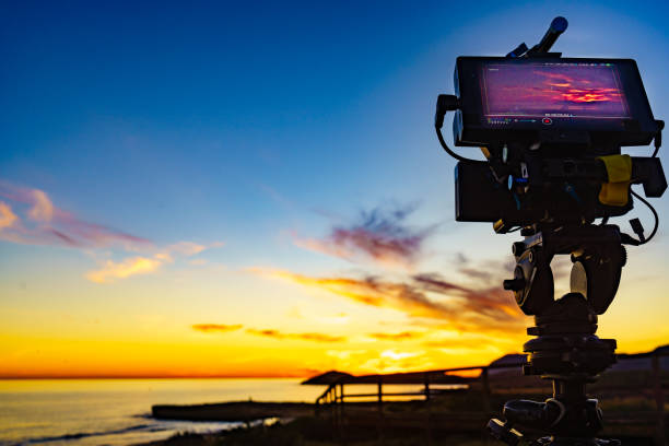 istock Camera taking picture of sunset over sea 1445425498