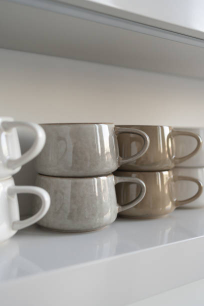 istock Row of ceramic mugs on shelf 1445425711