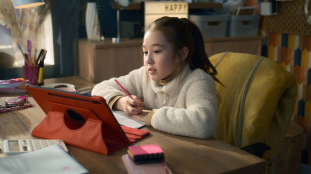 istock Schoolgirl studies on tablet 1445426676