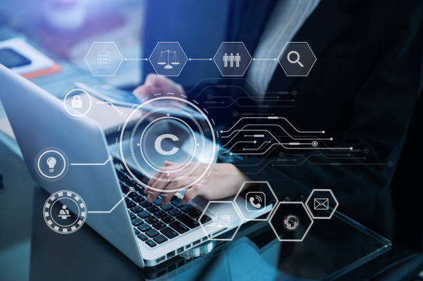 istock Copyright or patent concept, Person hand using laptop computer, tablet and smartphone with virtual screen copyright icon trademark, Creation ownership against piracy. 1445426798