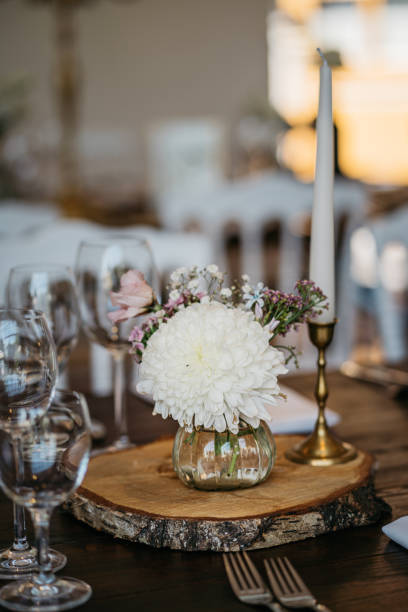 istock Romantic and rustic decoration with with a tree slice, white flowers and candles 1445427830