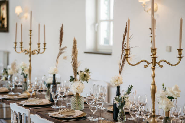 istock Boho inspired table setting with golden chandeliers, white flowers and pampas grass 1445427969