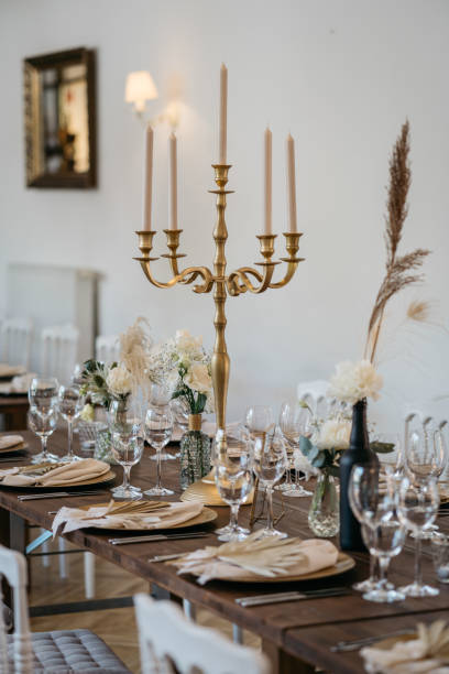 istock Boho inspired table setting with golden chandeliers, white flowers and pampas grass 1445427986
