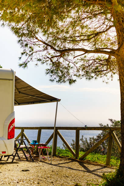 istock Camper and chairs on sea shore 1445429623