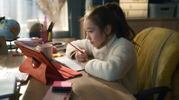 istock Schoolgirl studies on tablet 1445430093