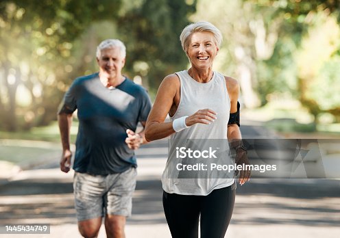 istock Retirement, couple and running fitness health for body and heart wellness with natural ageing. Married, mature and senior people enjoy nature run together for cardiovascular vitality workout. 1445434749