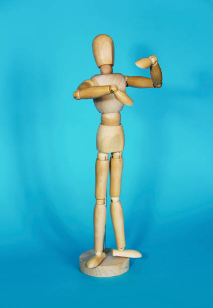 istock yellow wooden mannequin gestures with his hands on a blue background 1445434976