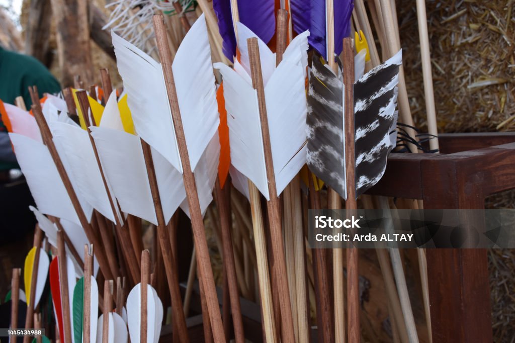 Colorful traditional arrows and arrowheads for archery Traditional colorful Wooden Arrows vertically gathered together in a bowl. Colorful traditional arrows and arrowheads for archery Bow Hunting Stock Photo