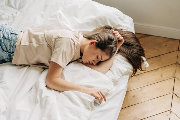 istock Young woman in home interior, relaxing in bed. 1445437968