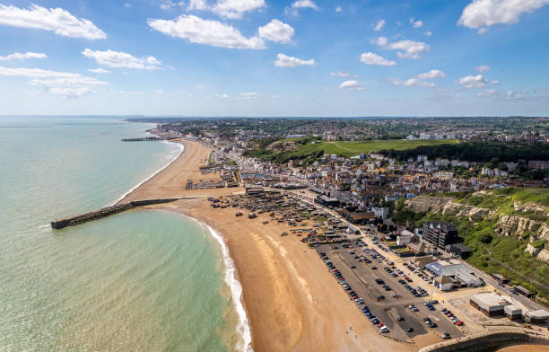 The drone aerial view of Hastings beach and city, England. Hastings is a large seaside town and borough in East Sussex on the south coast of England. east sussex stock pictures, royalty-free photos & images