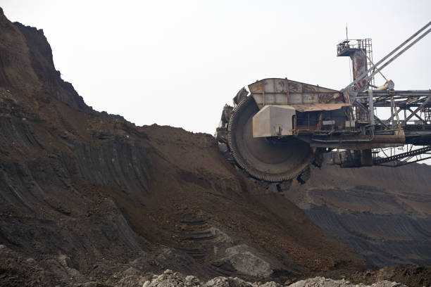 istock Bucket-wheel excavator during excavation at the surface mine. Huge excavator on open pit mine. 1445443586