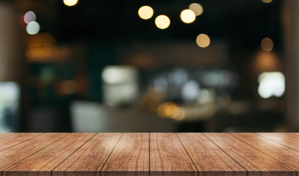 istock Empty wooden table top with lights bokeh on blur restaurant background. 1445445380
