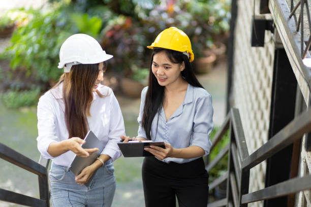 istock Female architect colleague is inspecting a construction project site, Colleagues discuss construction project improvement building and renovation planning. 1445450740